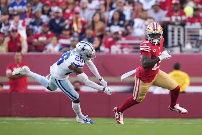 San Francisco 49ers wide receiver Deebo Samuel runs the football against Dallas Cowboys defense.